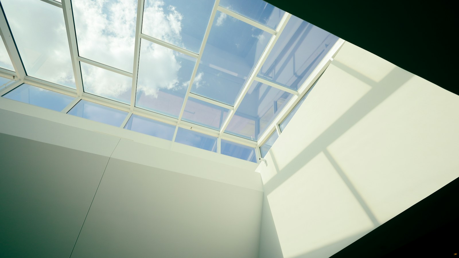Daylight entering a quiet room through a skylight, representative stock photography